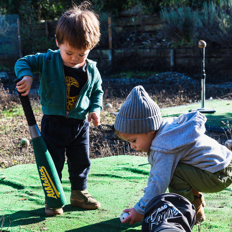 Children playing baseball at the best day care near me in Oakland, CA